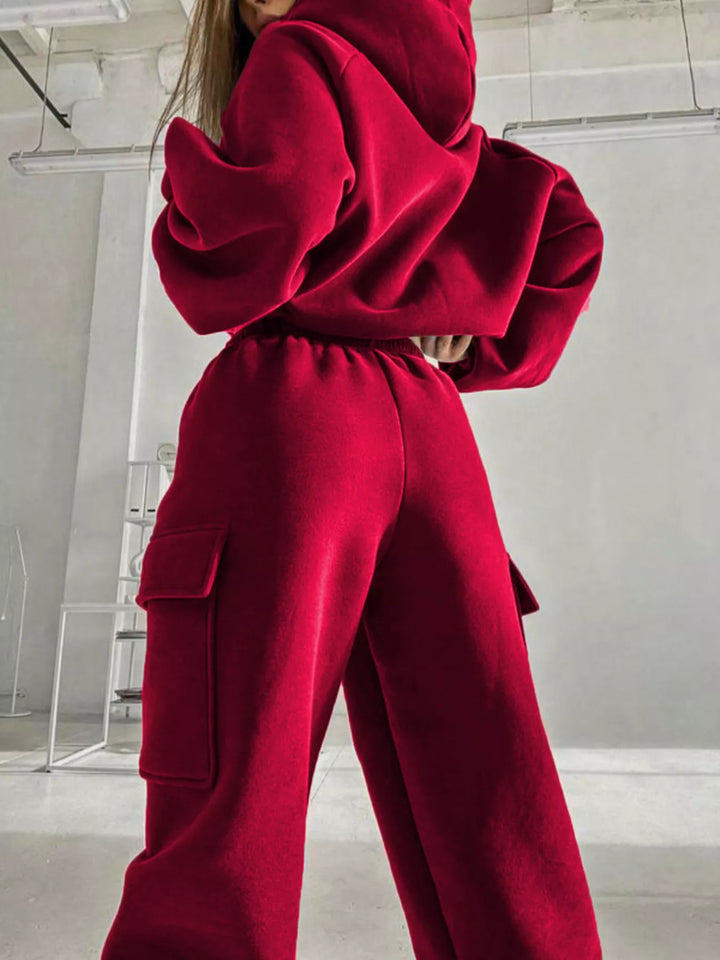 Red sweatsuit side view with hooded top and large cargo pocket