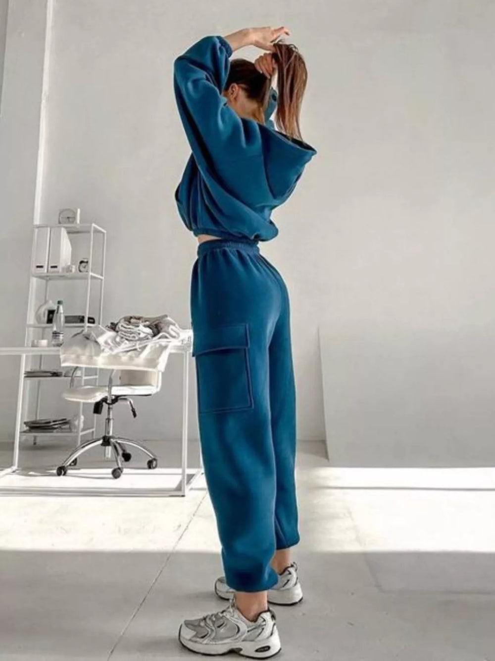 Full-length side view of the teal blue hoodie and cargo jogger set