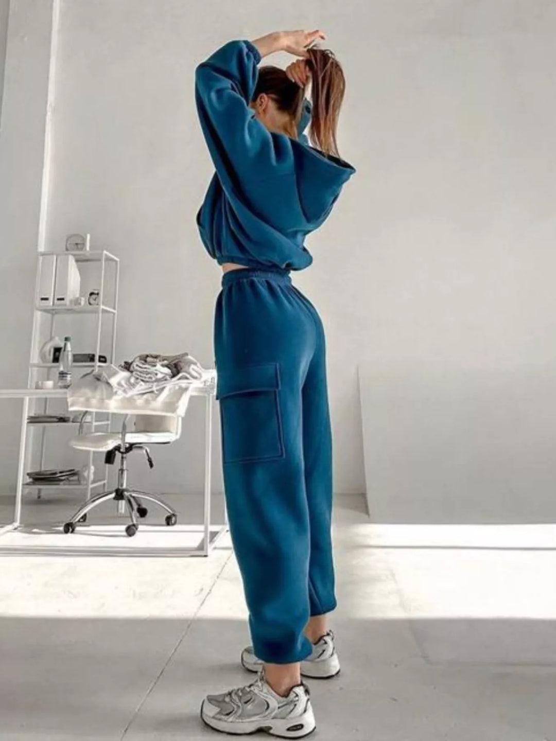 Full-length side view of the teal blue hoodie and cargo jogger set