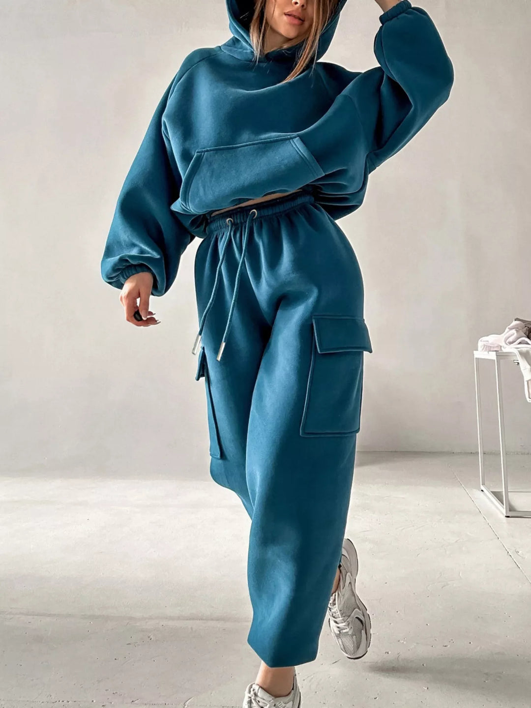 Women's sweatsuit in teal blue, hoodie and cargo joggers set, front view