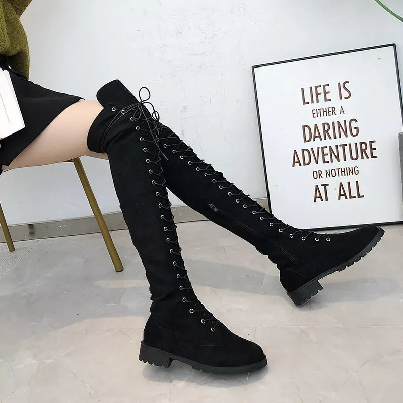 Side view of black thigh high lace up boots with low block heel
