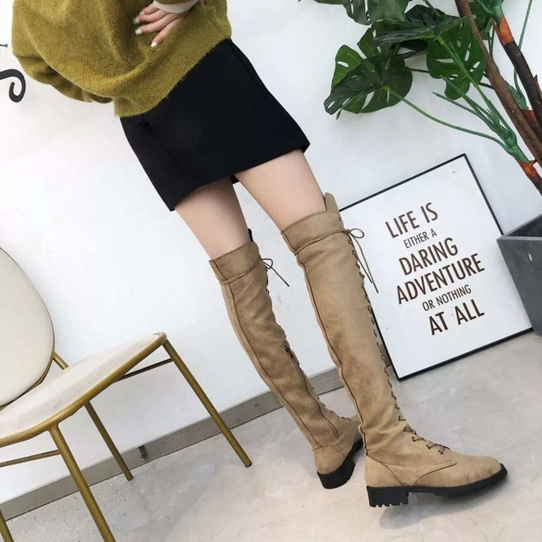 Full-length view of camel thigh high boots with an olive sweater