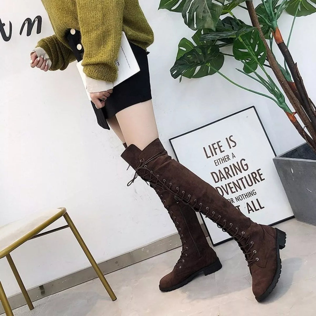Full-length view of dark brown lace up boots with a mustard sweater