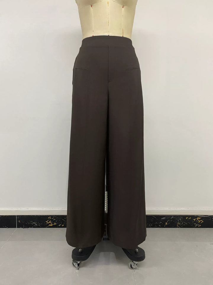 Back view of the coffee brown high waisted trousers on a mannequin