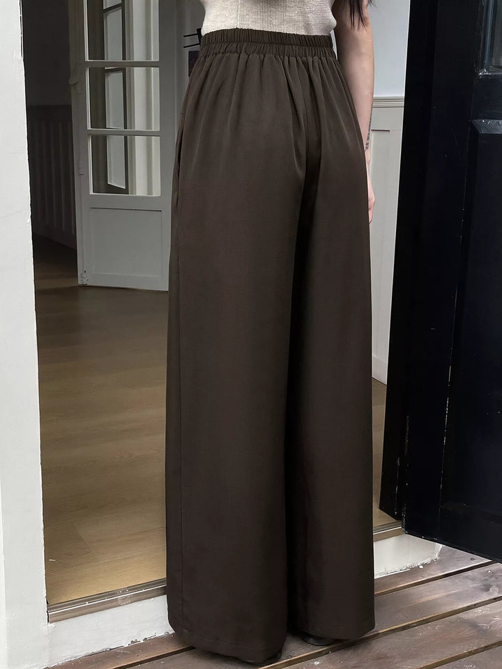 Back view of the coffee brown wide leg trousers with an elastic waist