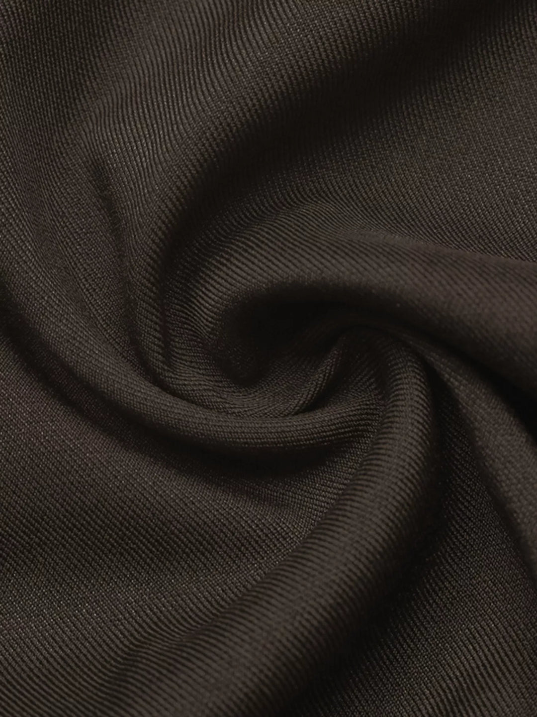 Fabric close-up of the coffee brown trousers twisted to show the texture