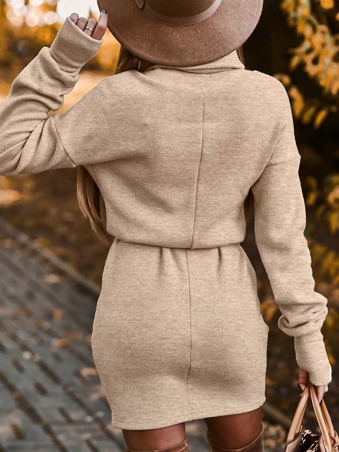 Khaki sweater dress worn on a model, showing the turtleneck