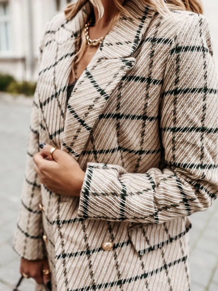 Close-up of the beige plaid blazer lapel and gold buttons