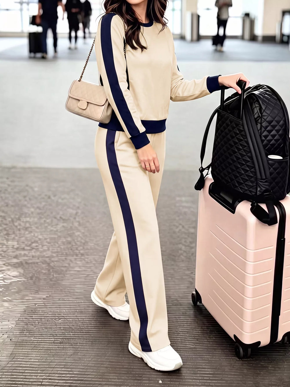 Beige two piece set with navy contrast side stripes, side view walking