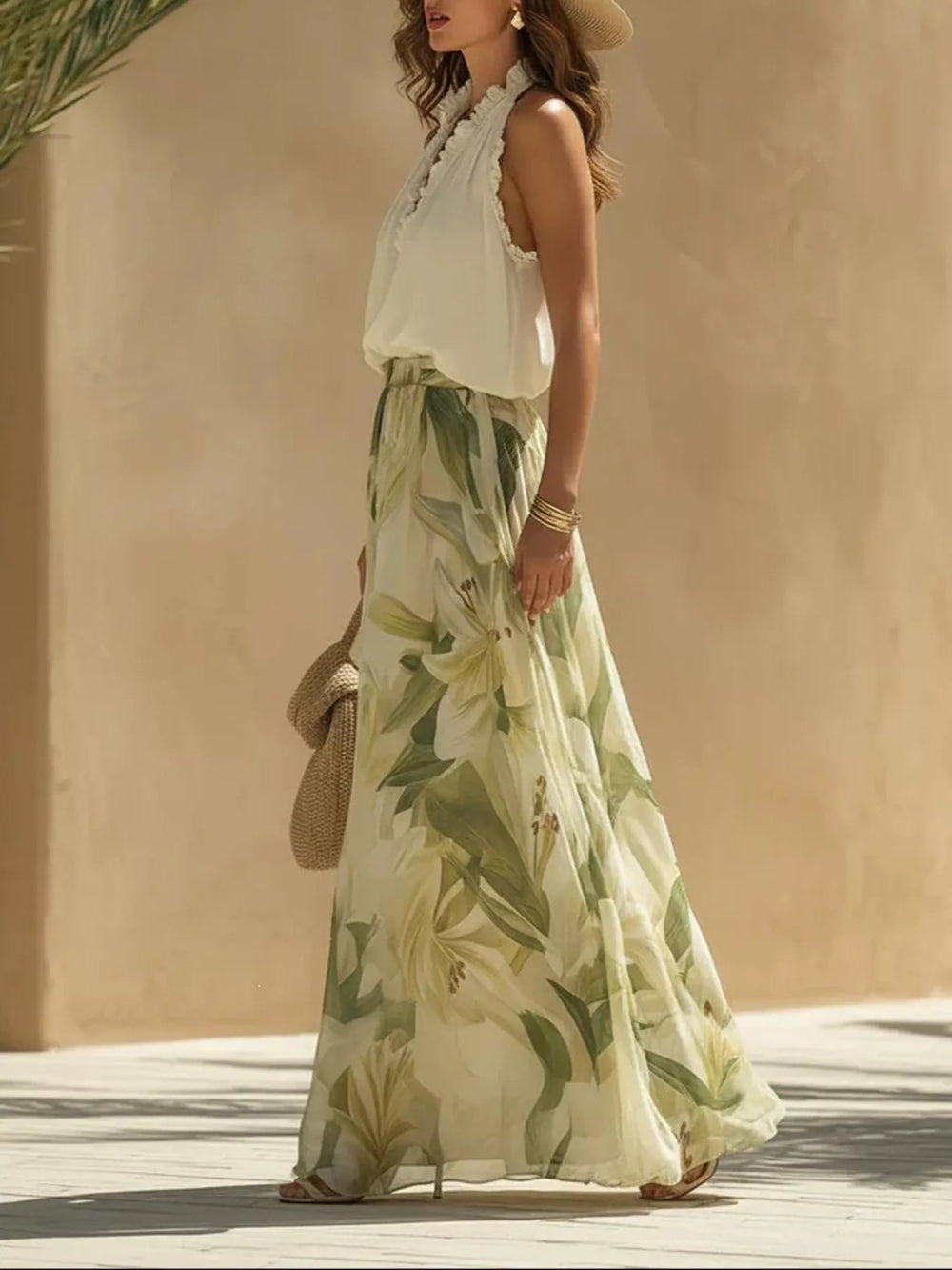 Side view of the halter top and leaf print wide leg pants while walking