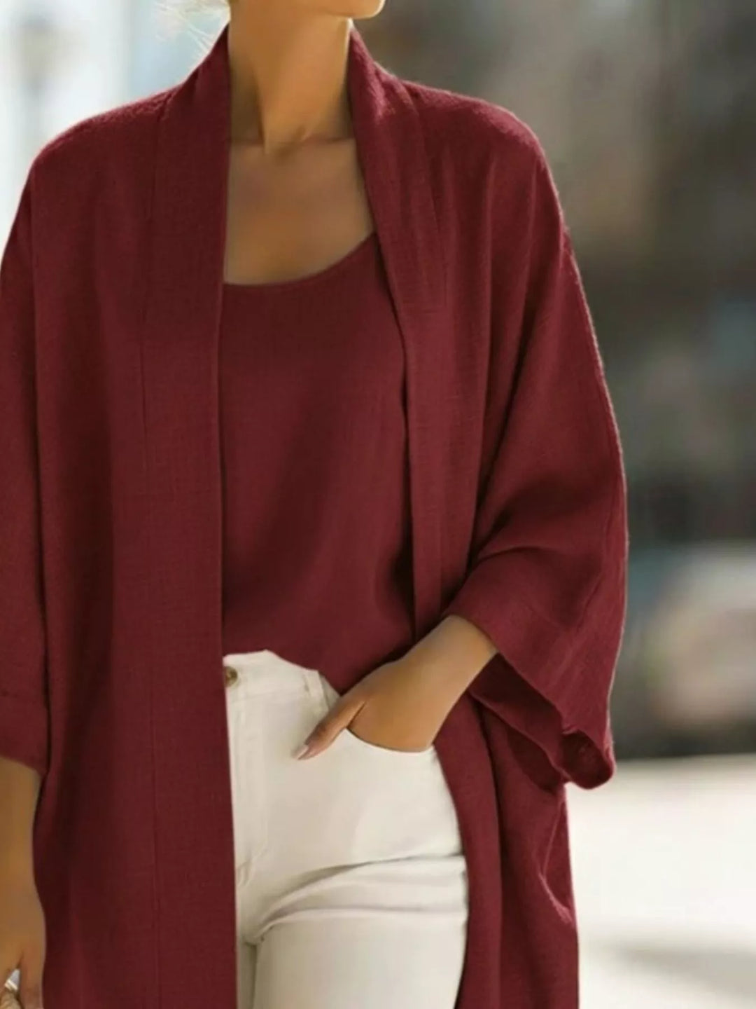 Close-up of the burgundy open front cardigan with wide sleeves and matching tank