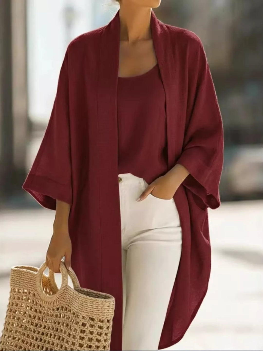 Burgundy kimono cardigan and tank two piece set with white pants and a straw tote