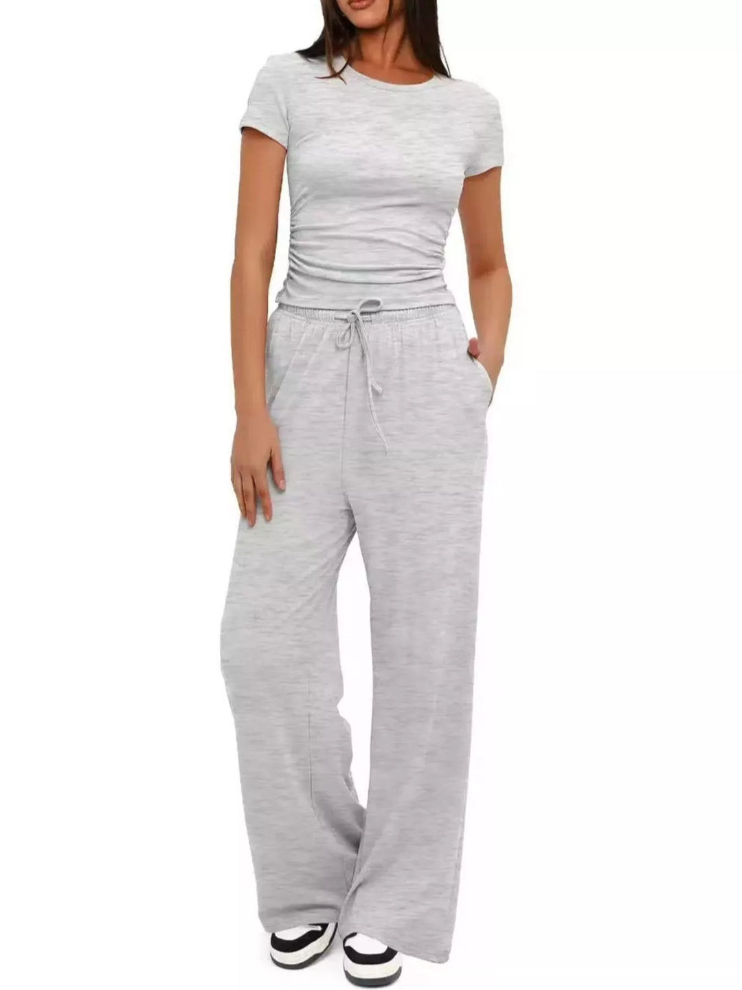 Women's two piece set in light gray, ruched crop top and wide leg pants, front view