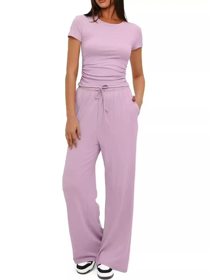 Lilac crop top and wide leg pants set with sneakers, front view