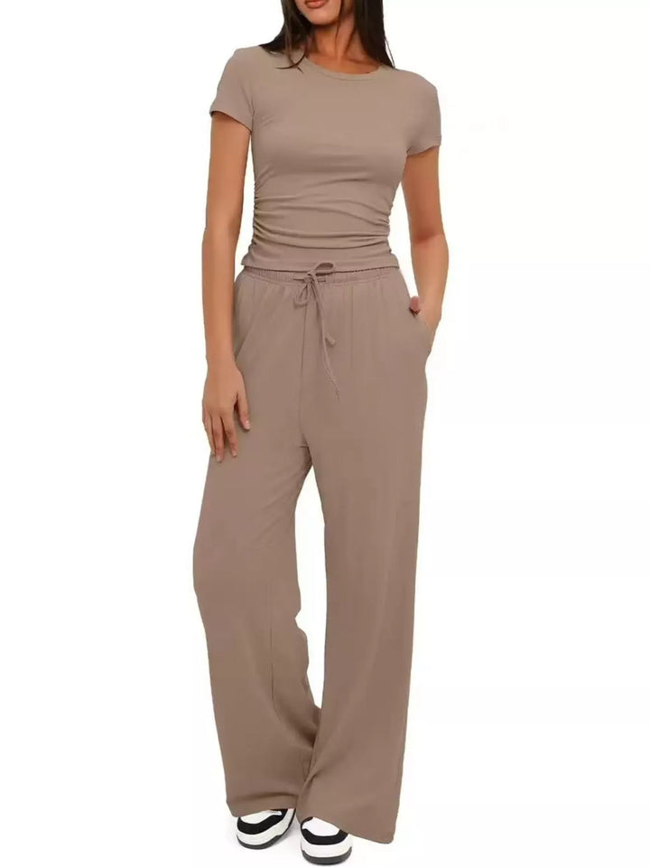 Taupe ruched crop top and wide leg pants set with a hand in the pocket