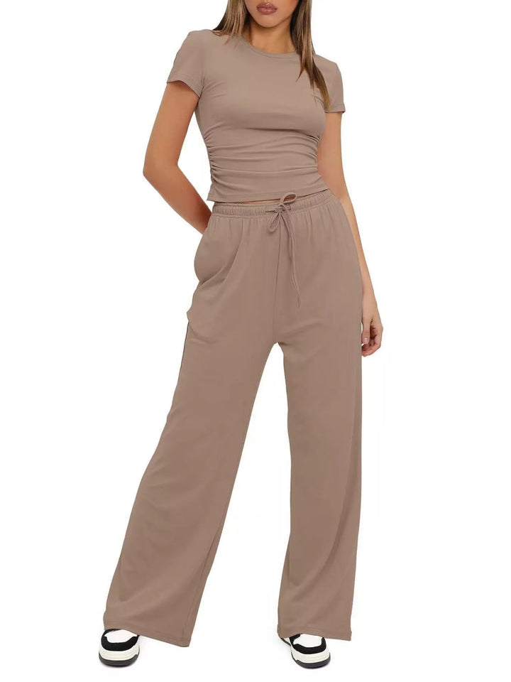 Taupe two piece set in a relaxed full length pose with sneakers