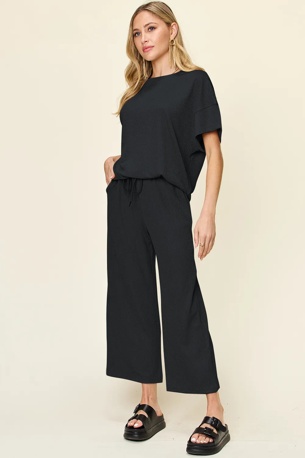 Black short sleeve top and cropped pants set, front view with chunky sandals