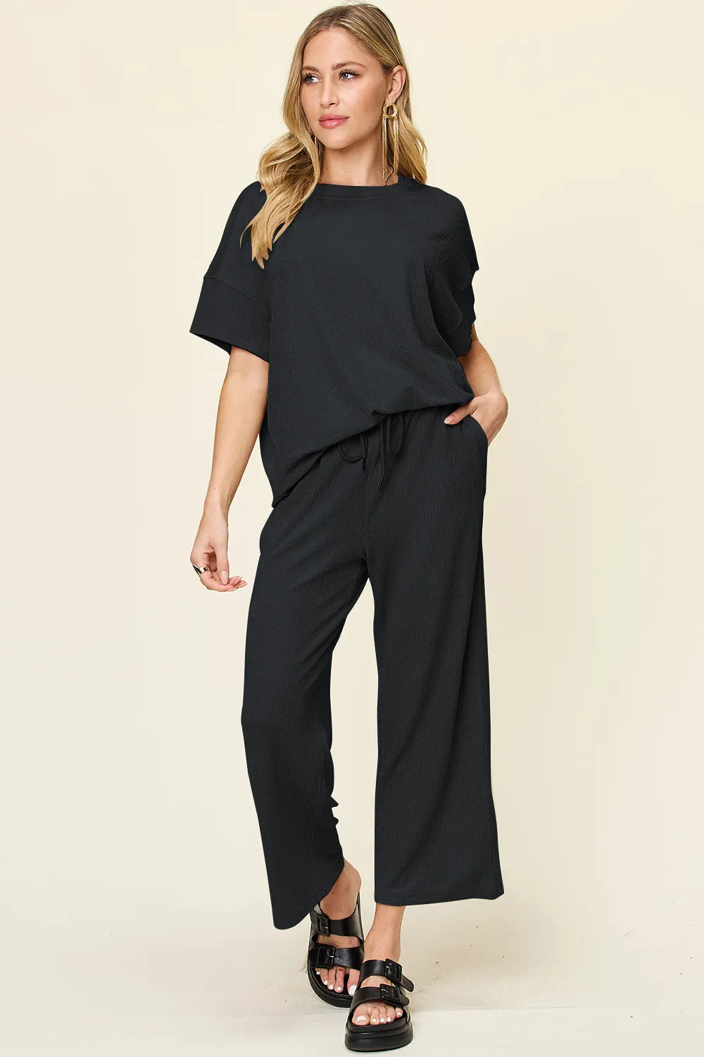 Black two piece set with short sleeve top and cropped wide leg pants