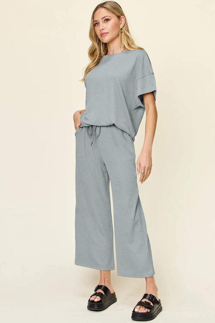 Dusty blue two piece set with short sleeve top and cropped pants