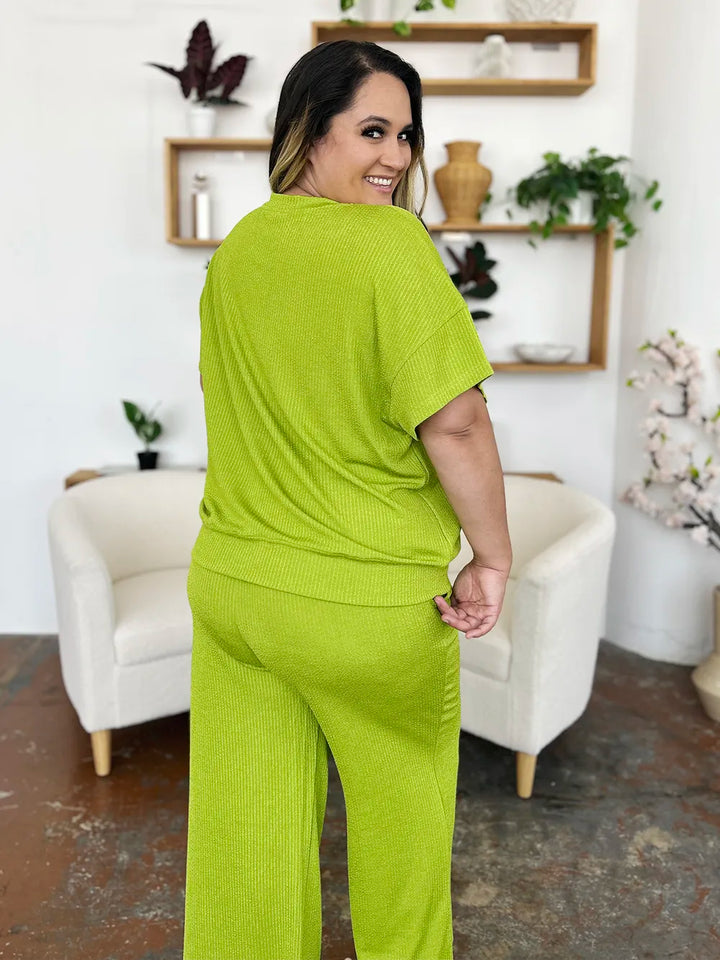 Back view of the lime green short sleeve top on a curvy model