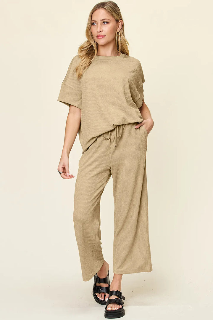 Tan two piece set with short sleeve top and cropped pants