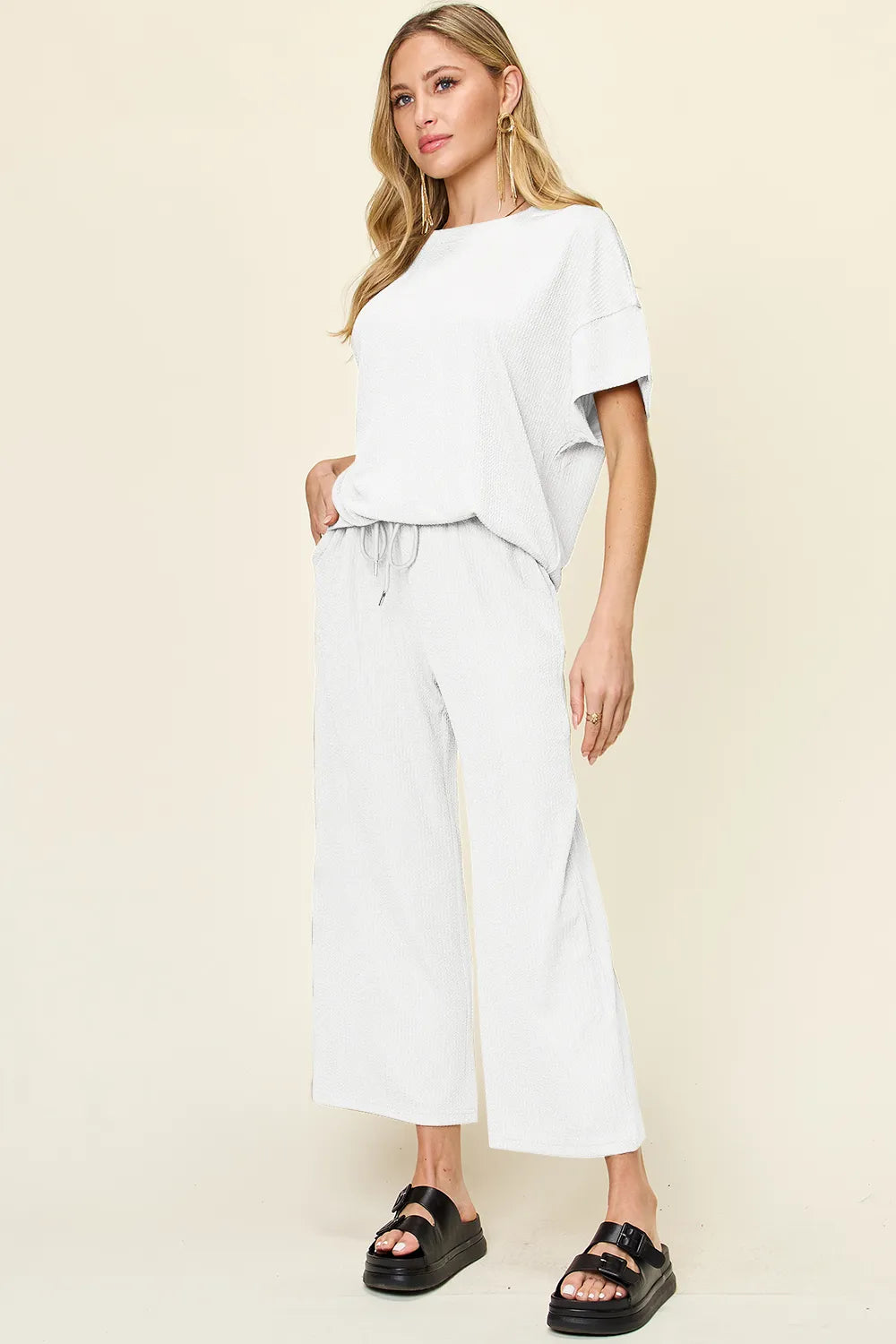 White two piece set with short sleeve top and cropped wide leg pants