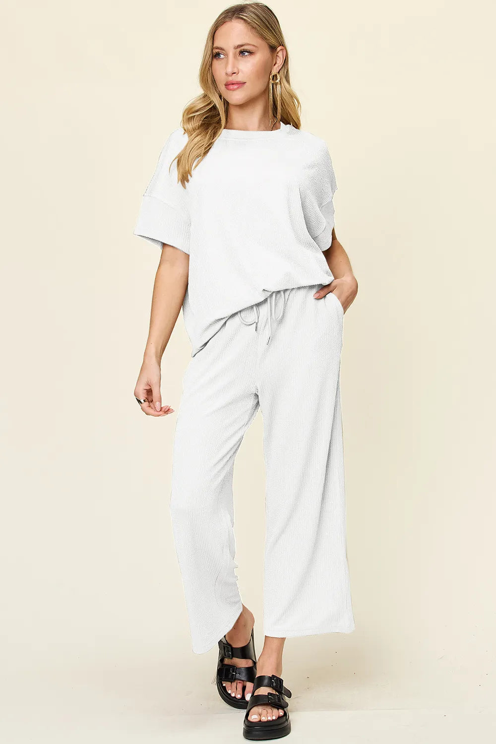 White short sleeve top and cropped pants, side angle with chunky sandals