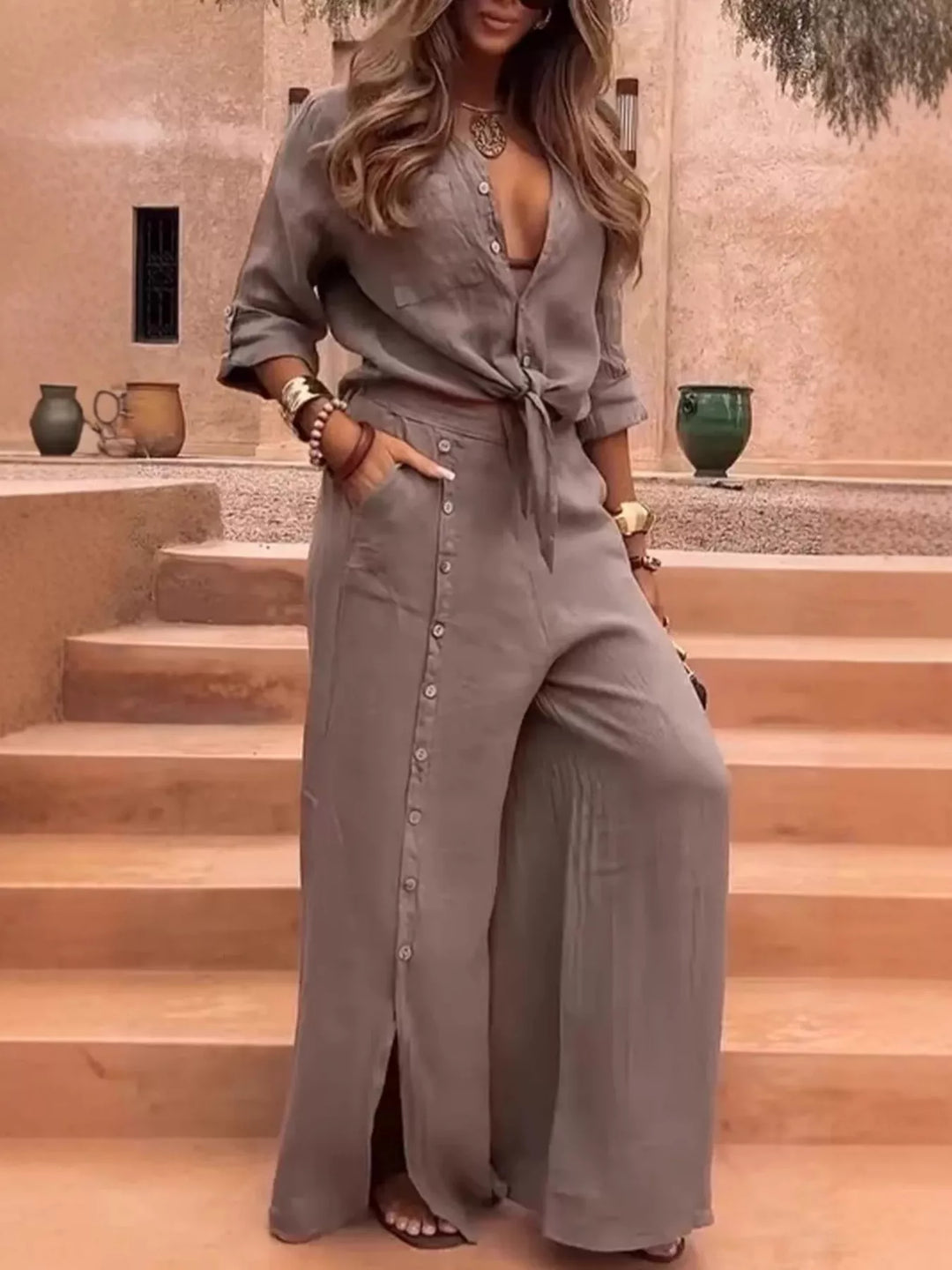 Taupe two piece set, tie front shirt and button front wide leg pants, standing outdoors