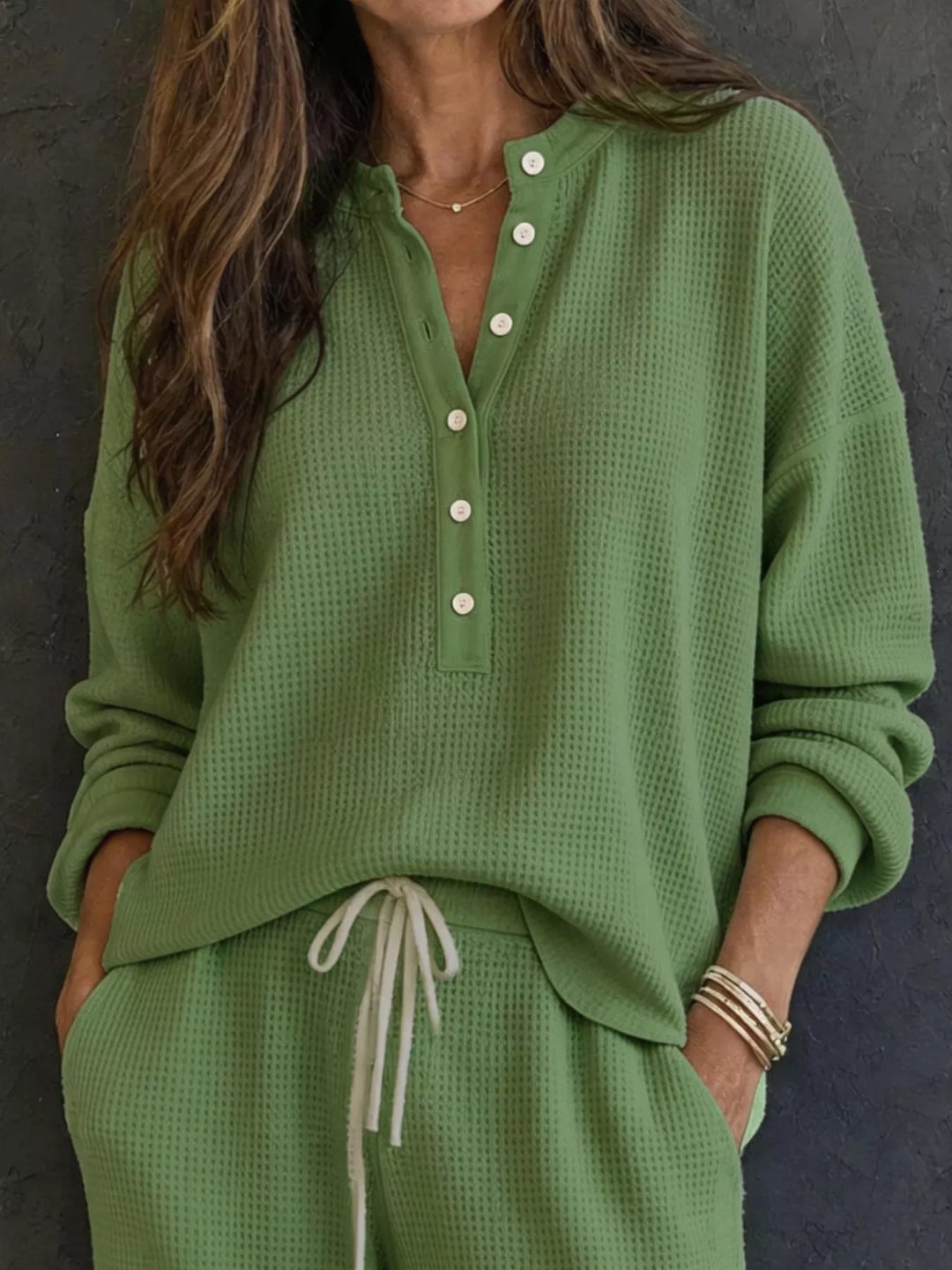 Matcha green waffle knit henley top with button placket and drawstring pants, close-up