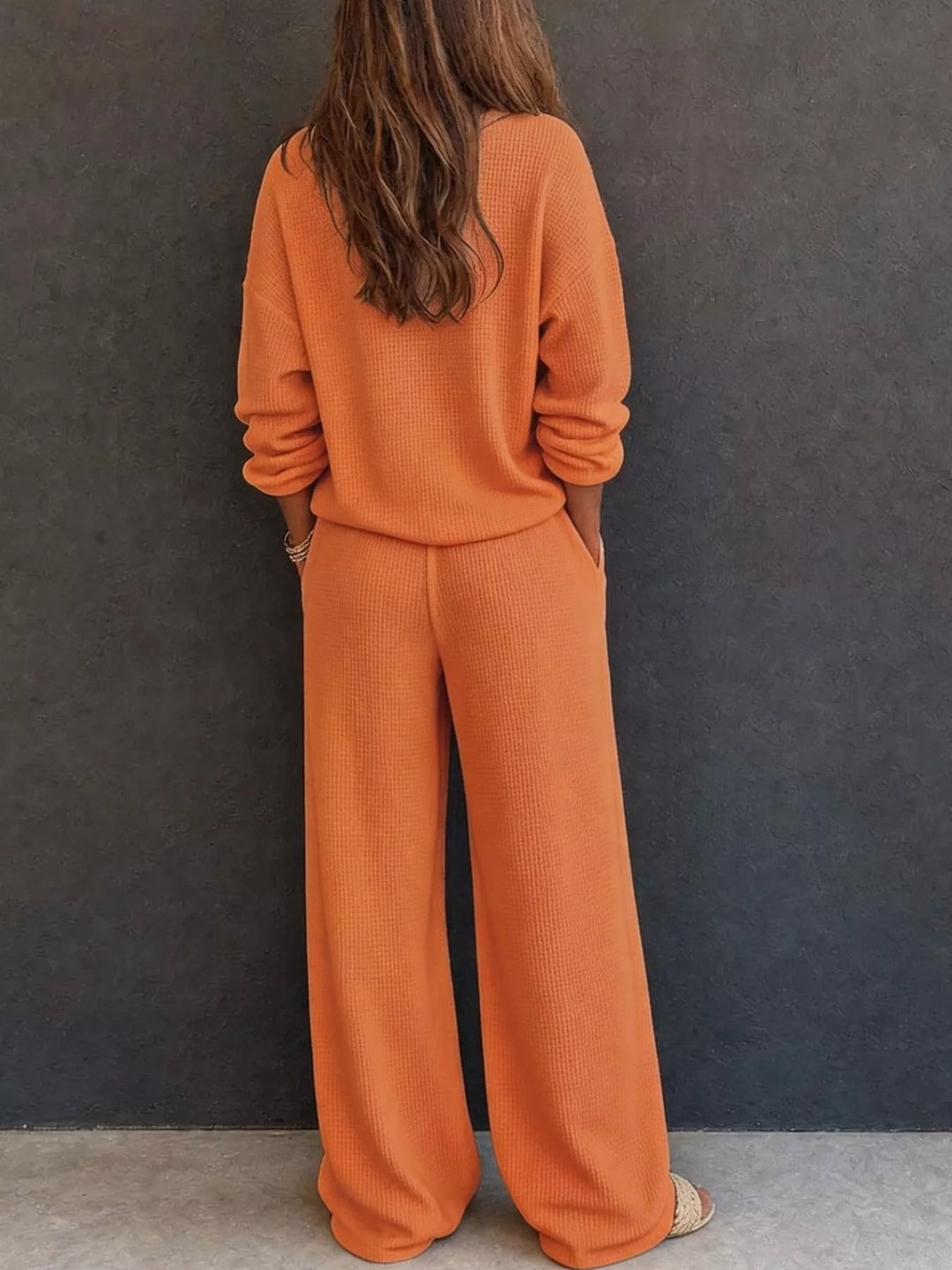 Back view of the orange waffle knit henley and wide leg pants set