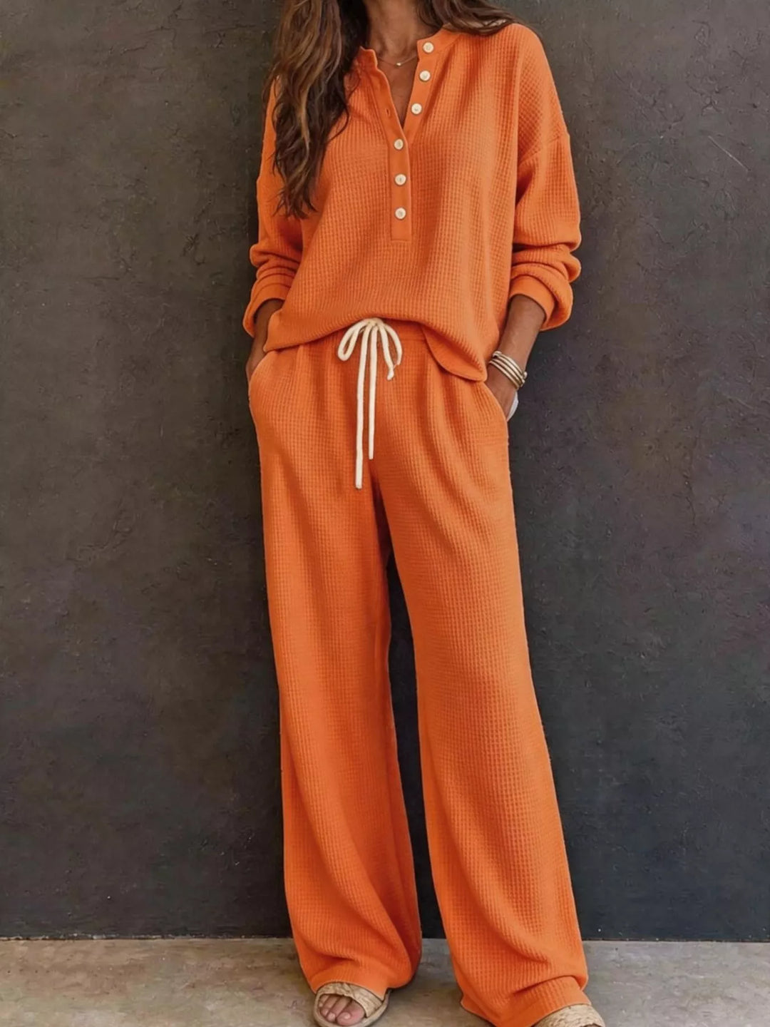 Orange two piece set with waffle knit henley and wide leg pants, full view