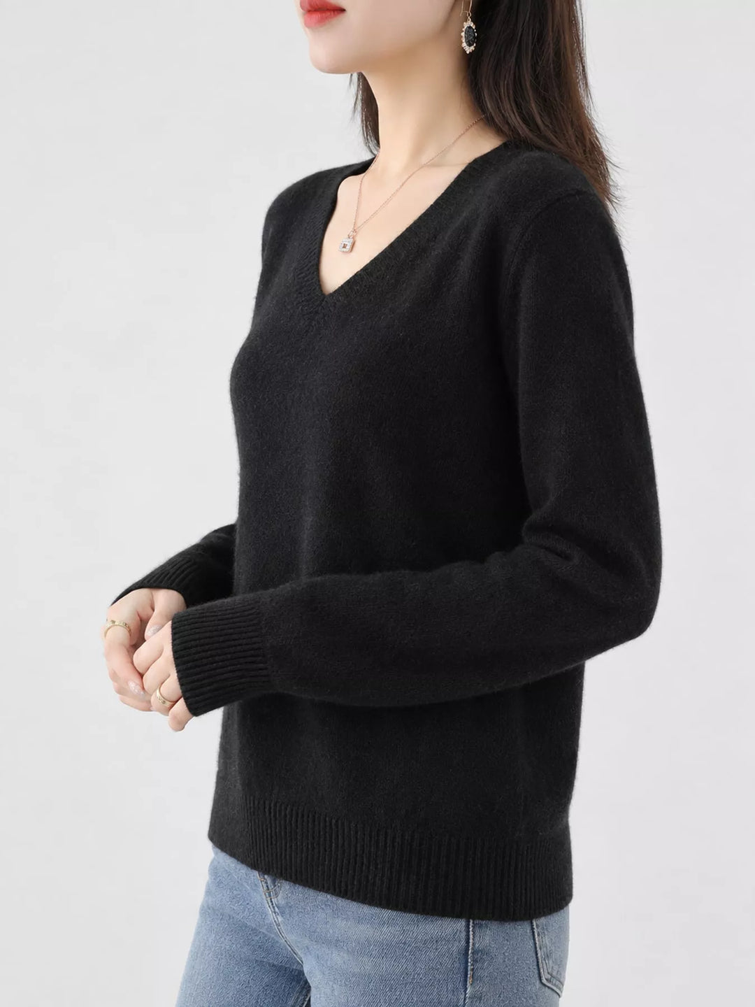 Black V neck sweater worn on-model, side angle with a relaxed fit