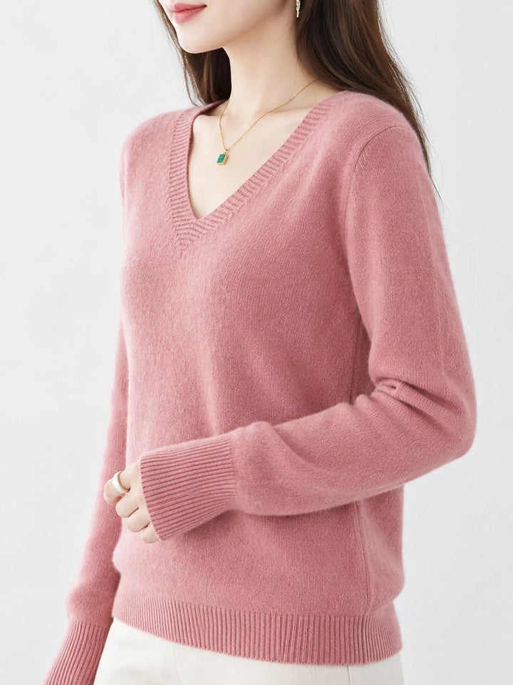 Pink V neck sweater worn on-model, side angle with a relaxed fit