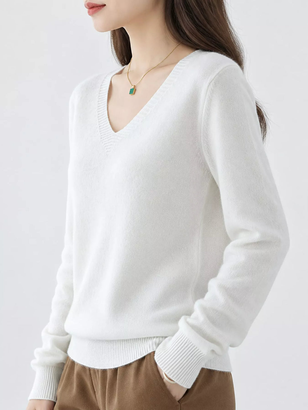 White V neck sweater worn on-model, side angle with a relaxed fit