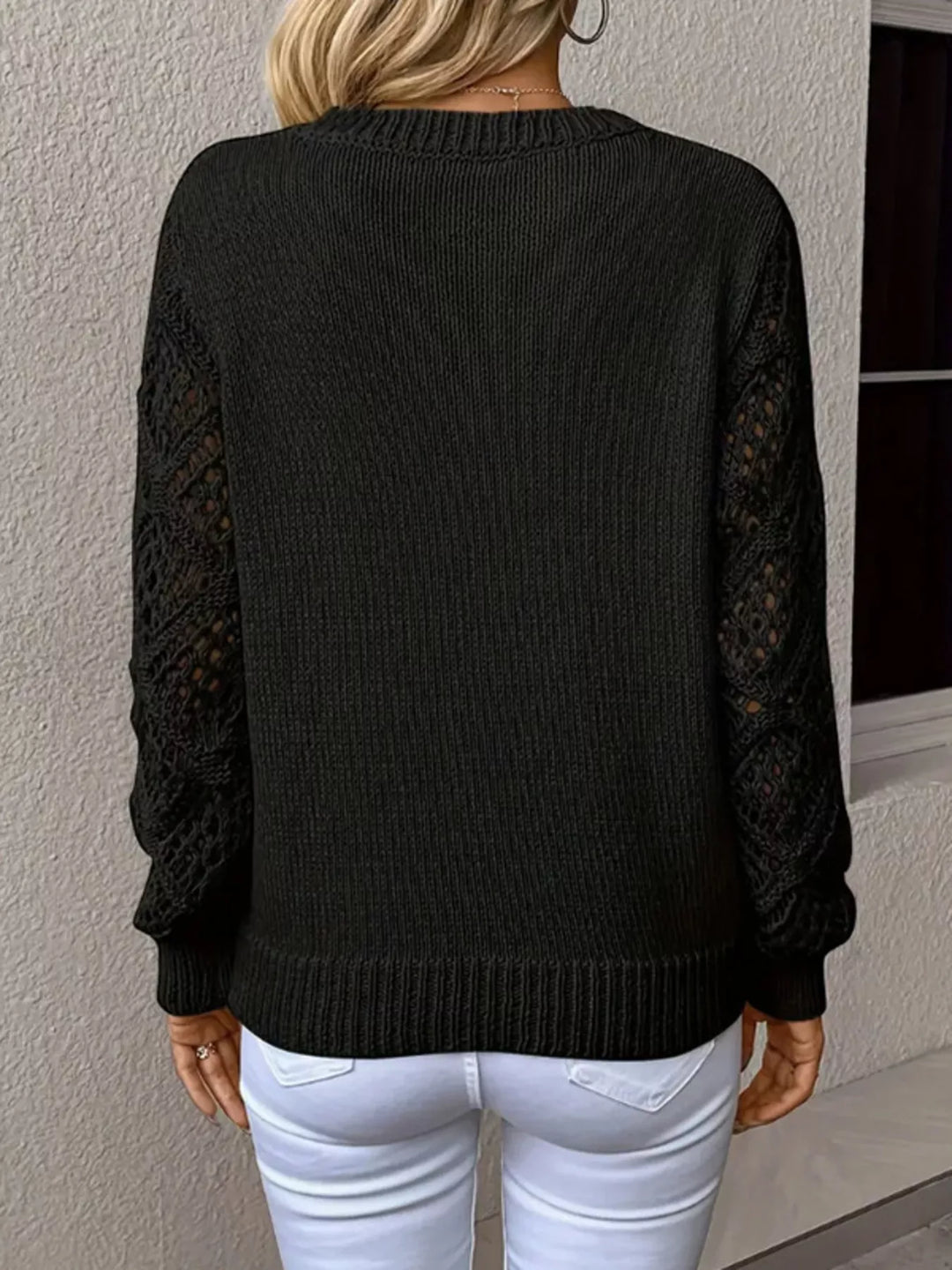 Back view of the black v neck sweater with cutout sleeves