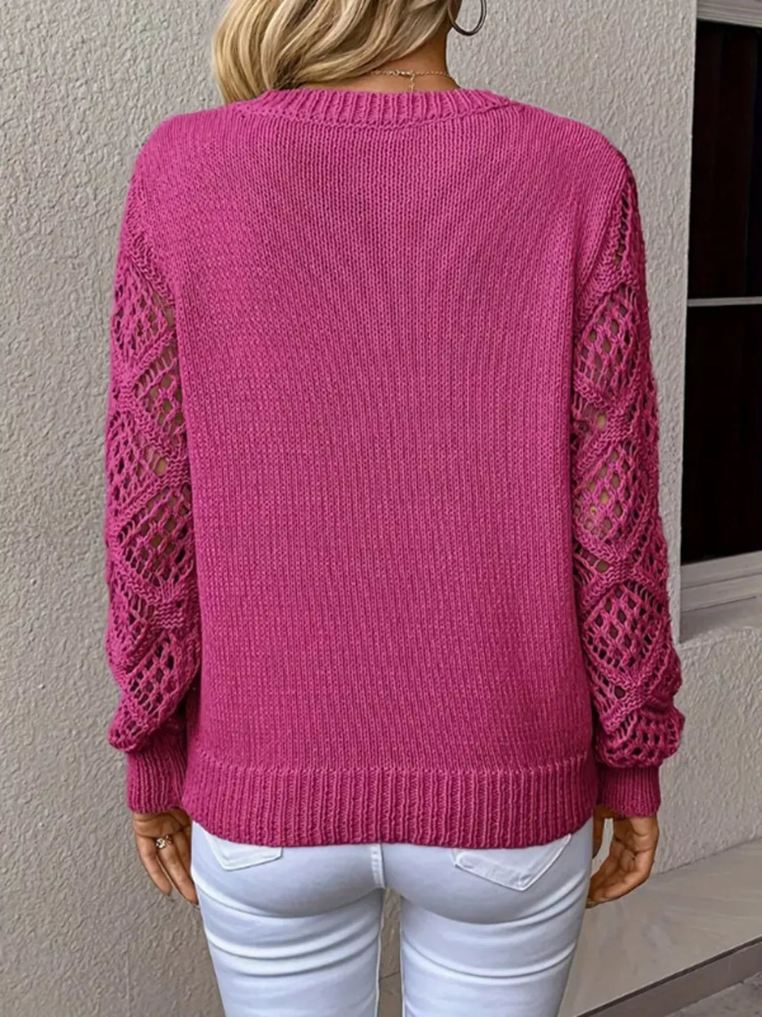 Back view of the fuchsia v neck sweater showing the openwork sleeves