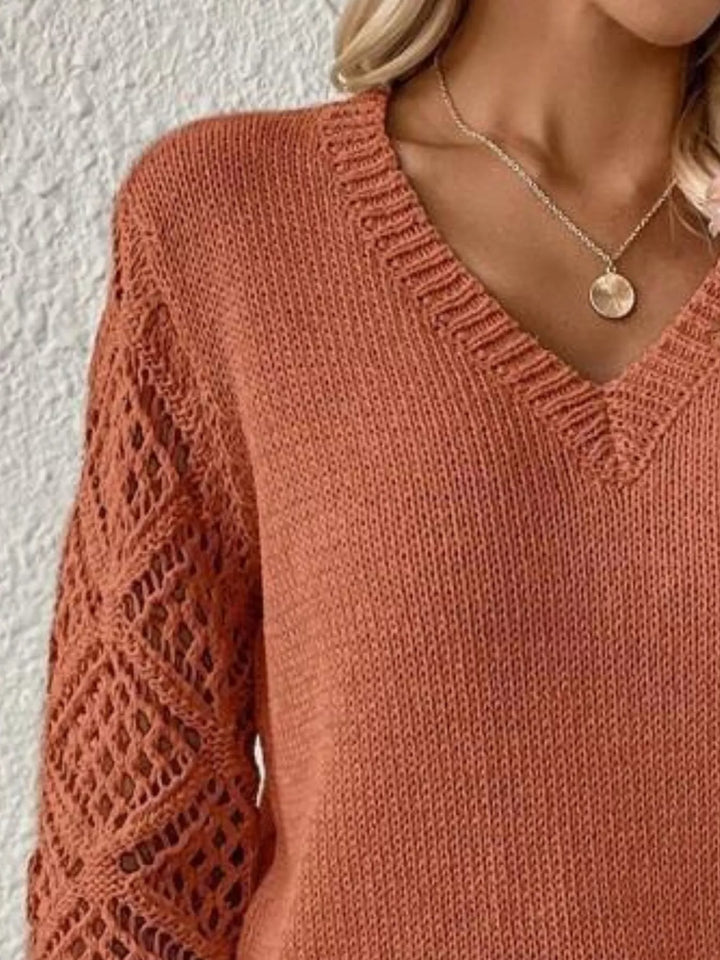 Close-up of the terracotta v neck collar and diamond cutout sleeve