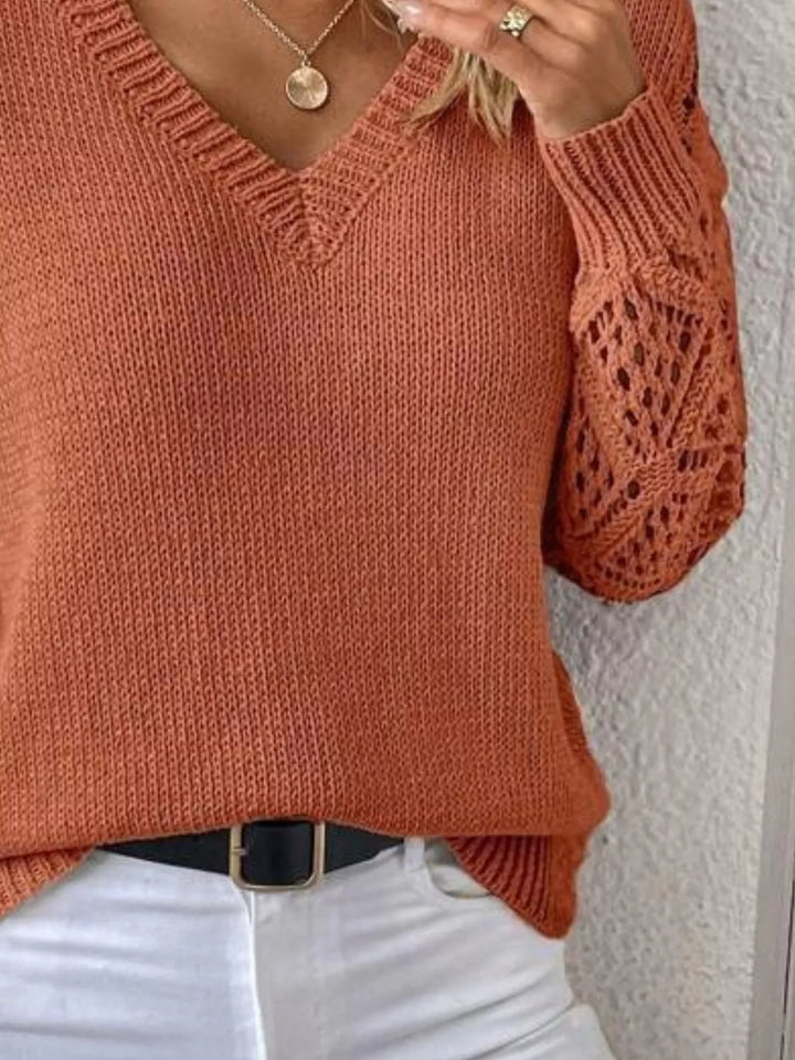 Terracotta sweater torso and cutout sleeve detail with a black belt