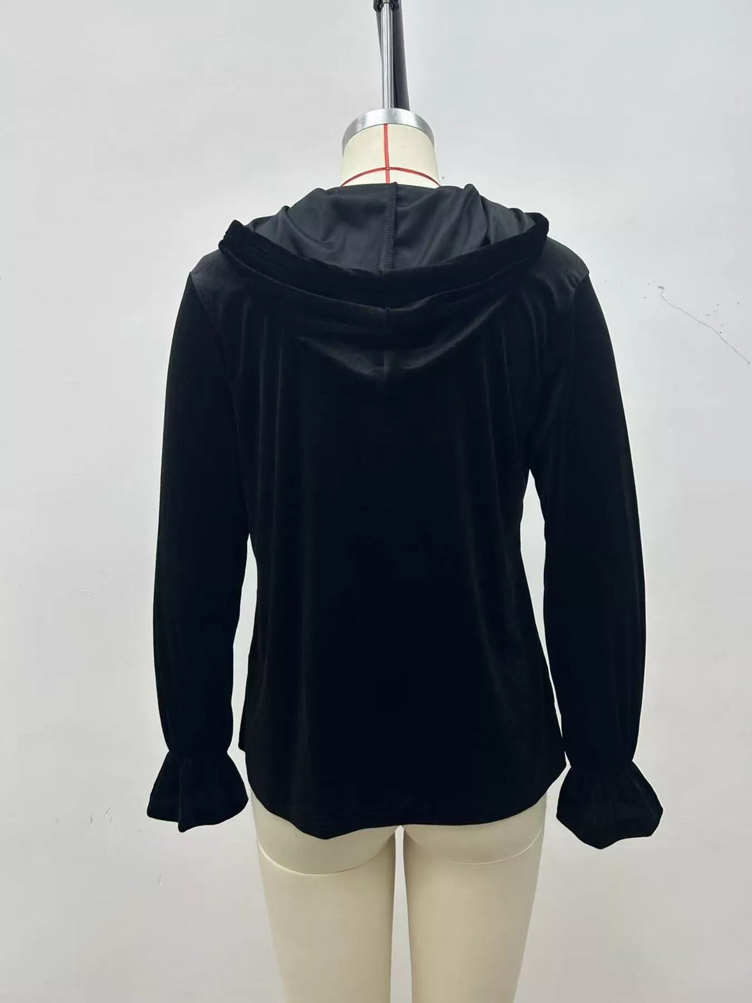 Black velvet jacket back view showing the smooth hood and flared sleeve ends