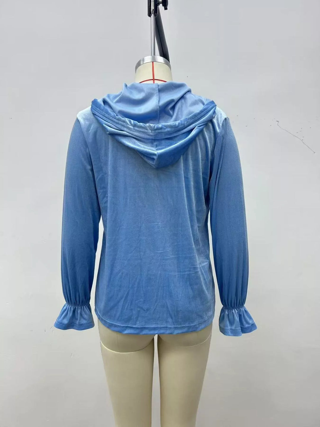 Sky blue velvet jacket back view showing the hood and flared cuffs