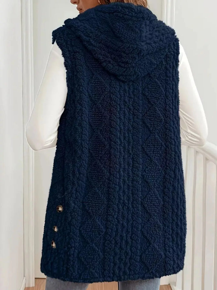 Back view of the navy hooded cable knit vest with side button detail