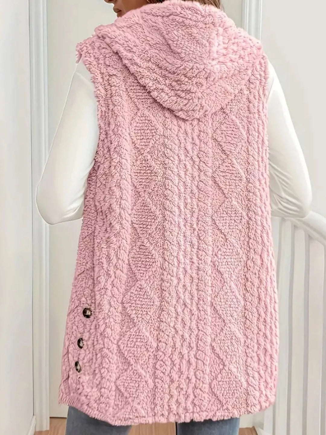 Blush pink hooded vest back view showing the cable knit pattern
