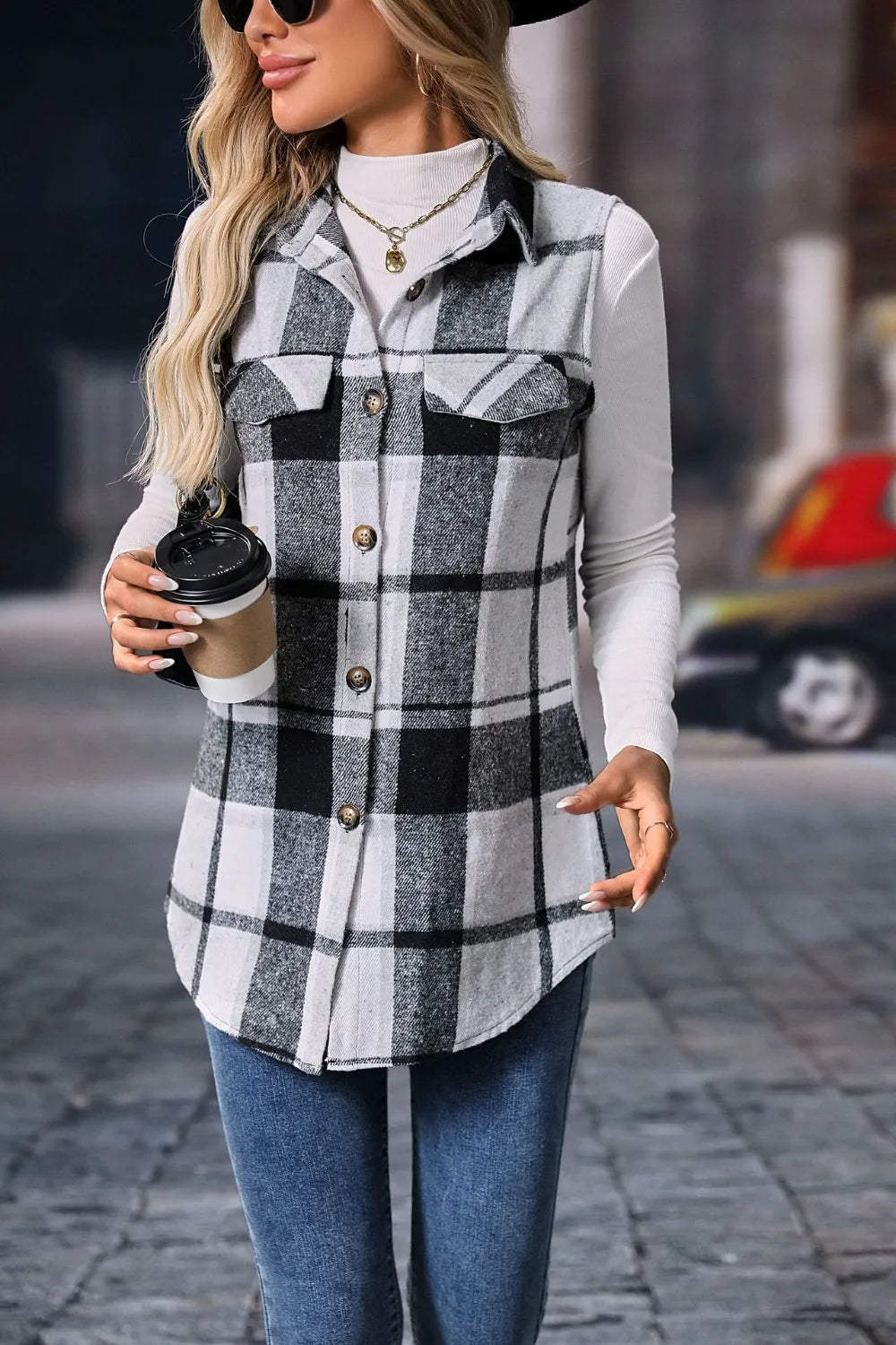Black and white plaid sleeveless vest with a curved hem