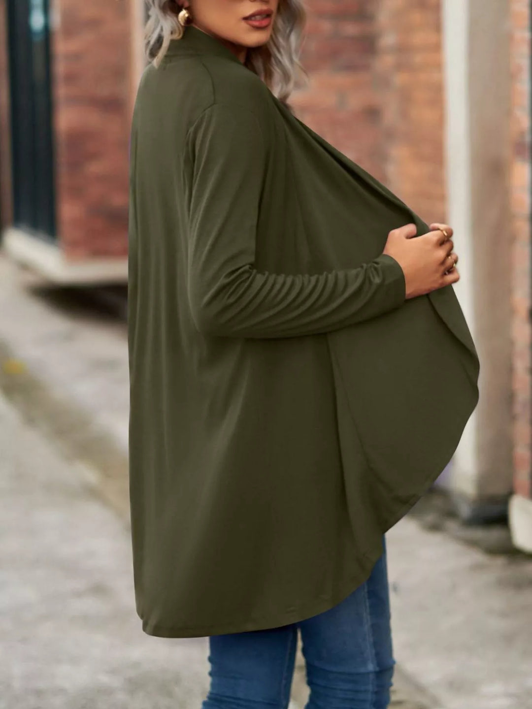 Side view of the olive green waterfall cardigan draping at the front