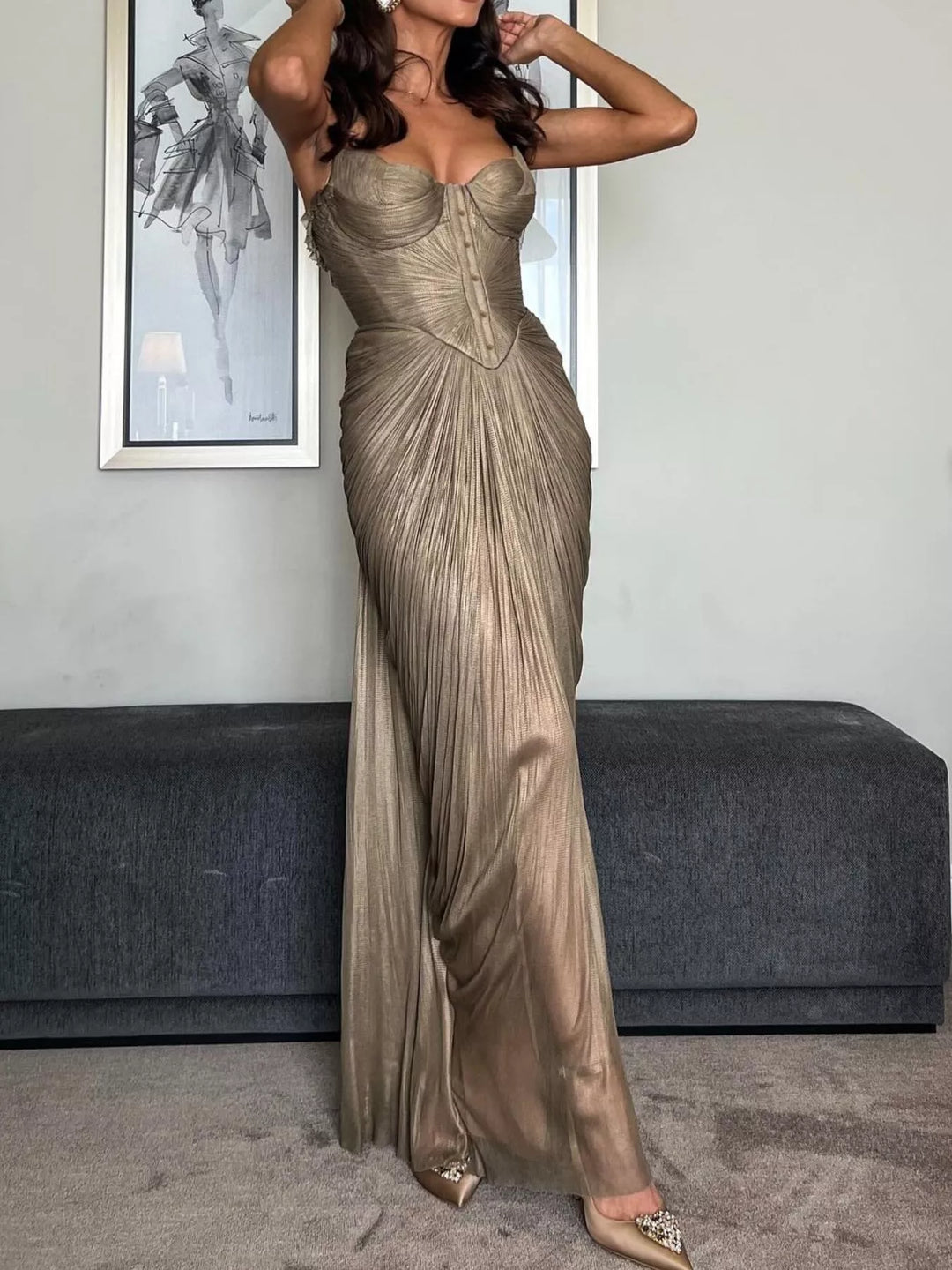 Gold maxi dress worn on a model, showing the metallic sheen