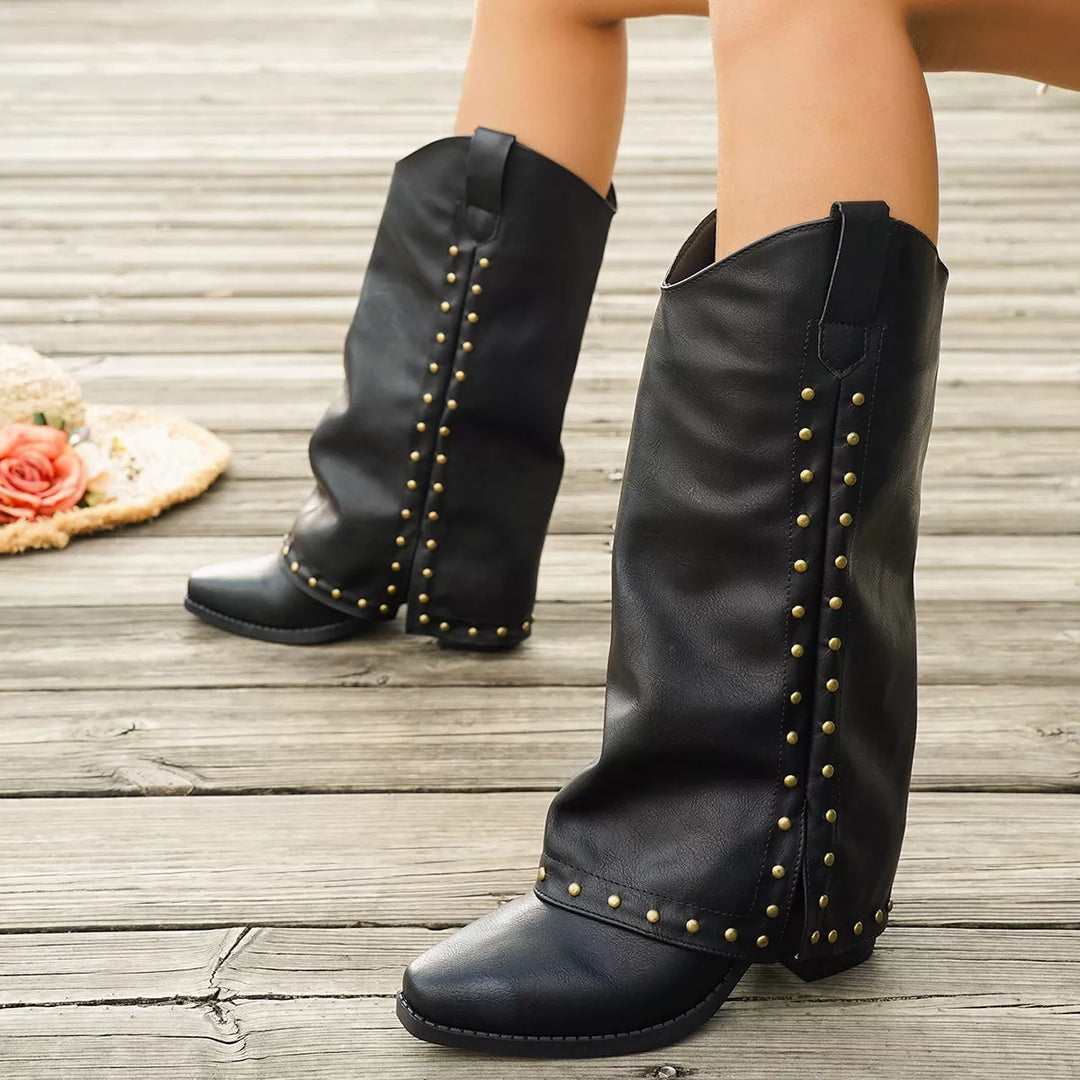 Close-up of the black western boots with stud trim and block heel