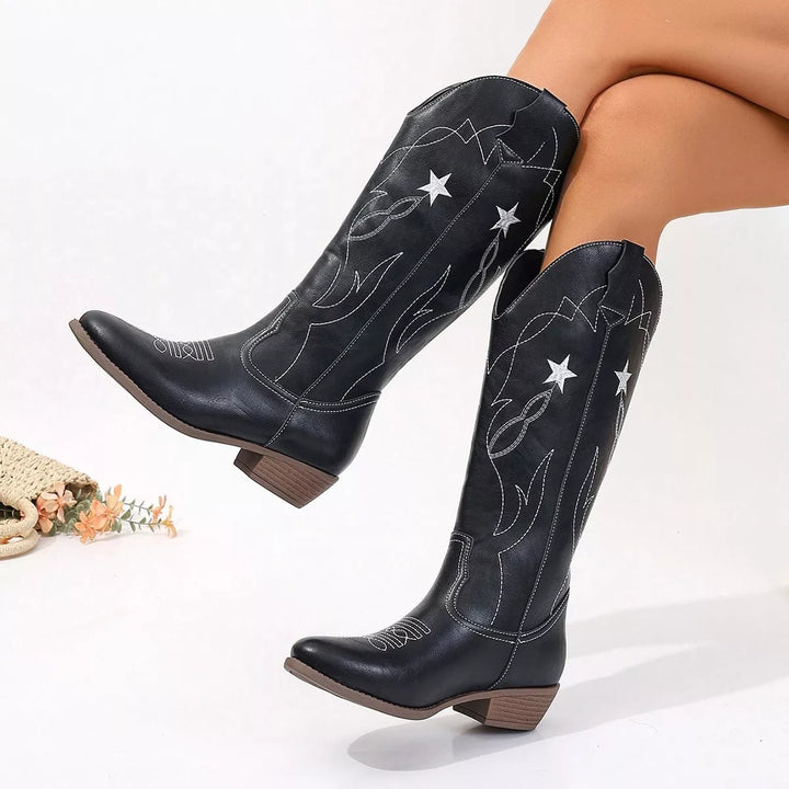 Women's western boots in black, star embroidered mid calf pull on, worn crossed