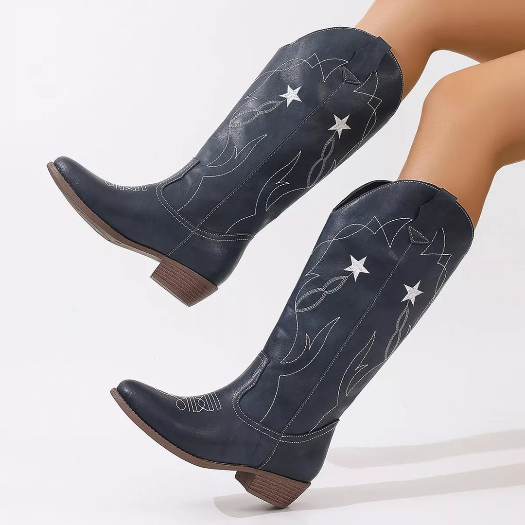 Navy western boots with white star embroidery, angled pair view