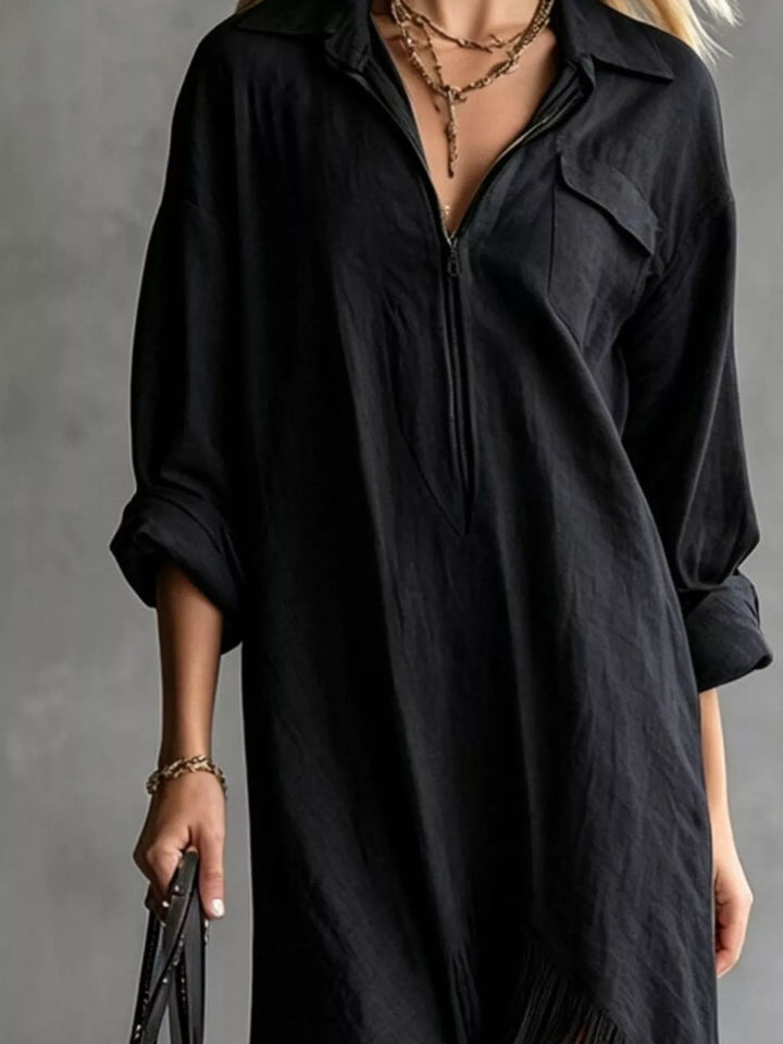 Black shirt dress worn on a model, showing the pointed collar