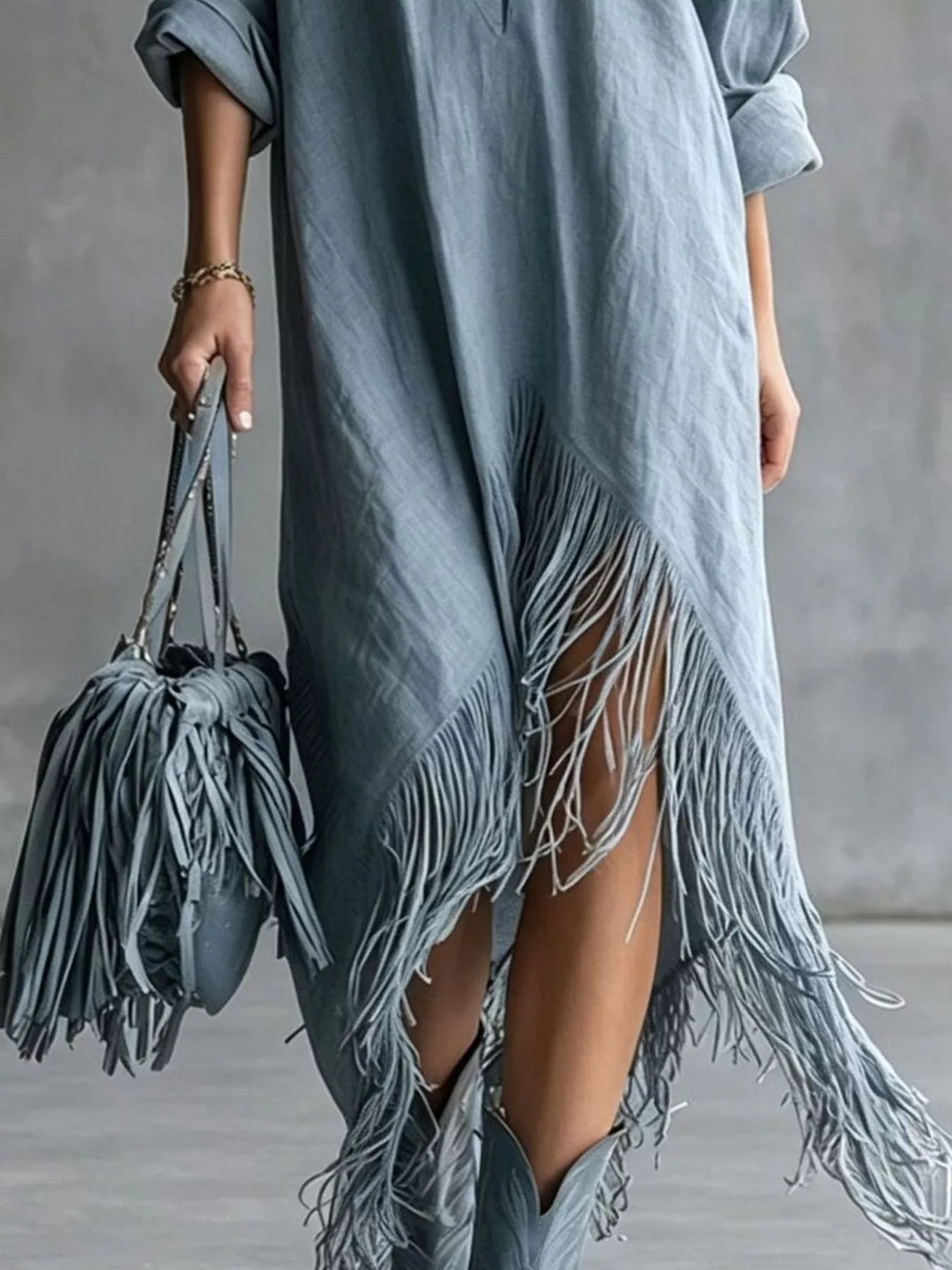 Dusty blue shirt dress worn on a model, showing the pointed collar